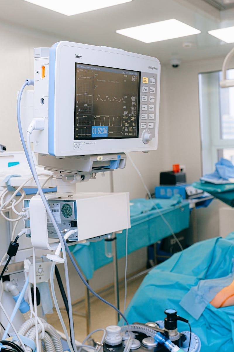 Vital signs monitor displaying heart rhythm in surgical setting
