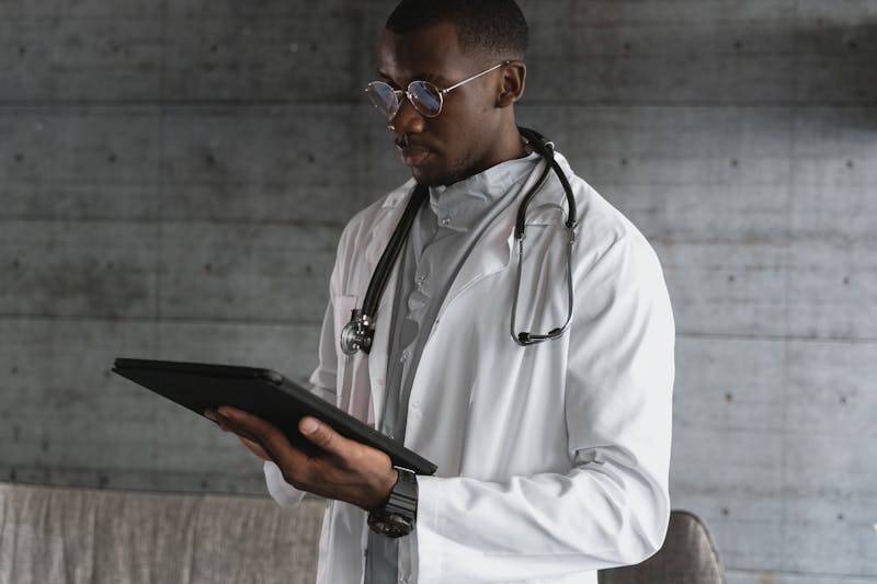Pain management physician reviewing patient records on tablet