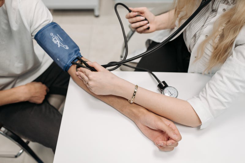Doctor measuring patient blood pressure during cardiovascular examination