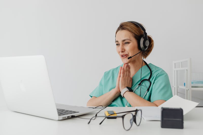 Healthcare provider conducting telehealth consultation via laptop